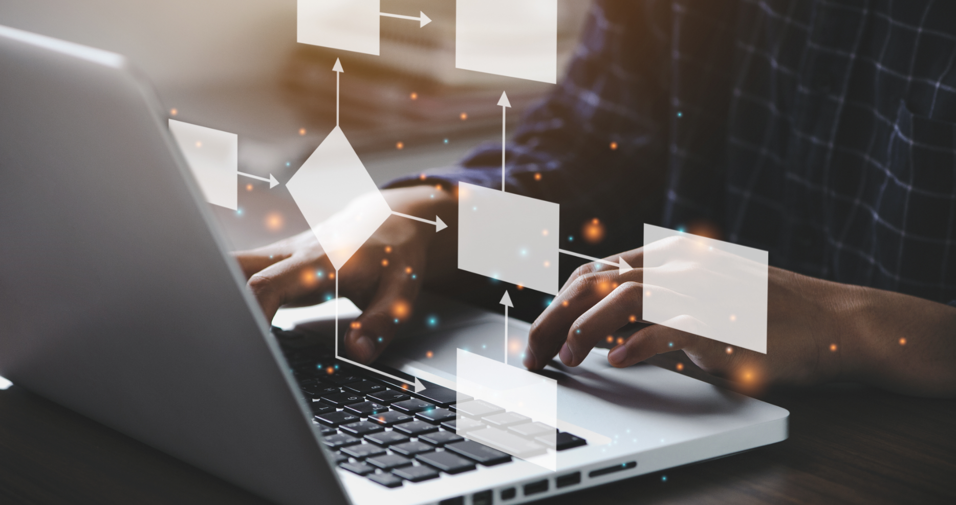 Two hands typing on a laptop and floating symbols demonstrating connections and networks.
