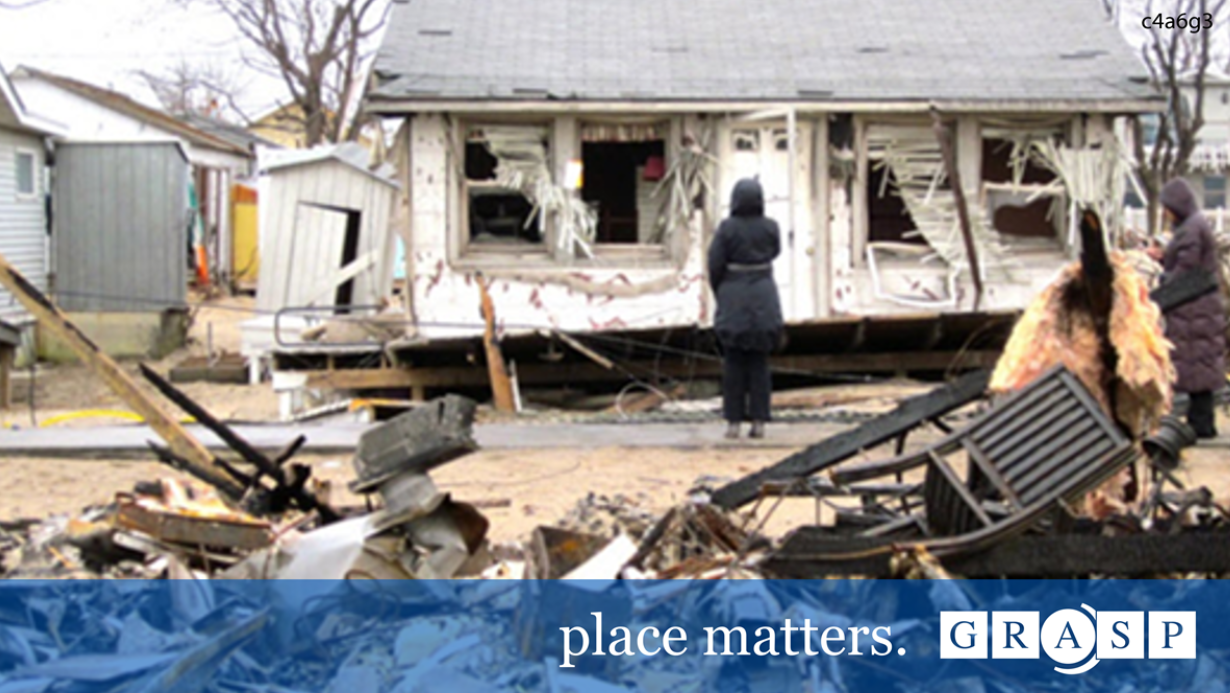 Woman in front of broken building. Place matters. GRASP.