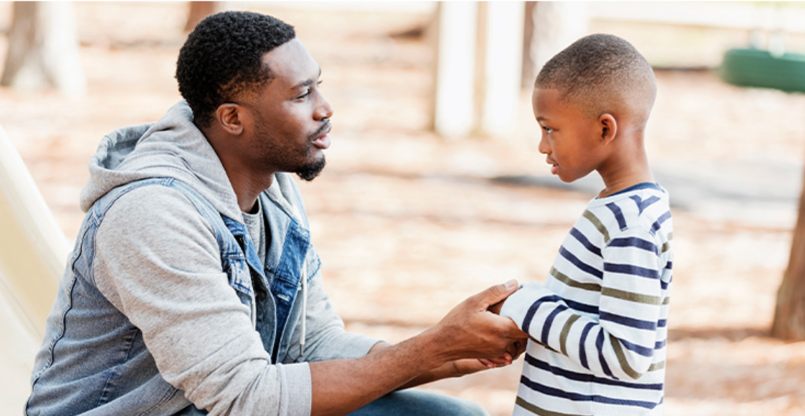 A man talking to a child