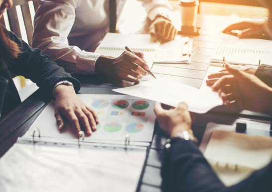 a group of business people in a meeting, close up of hands and documents