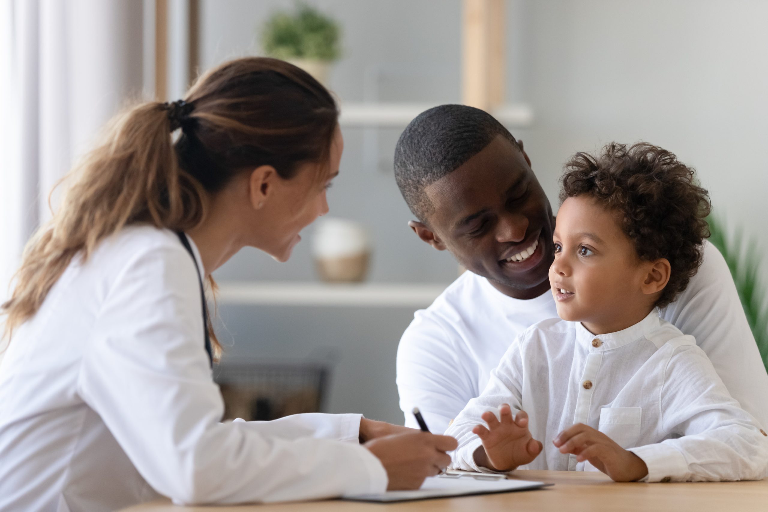 A father and son meet with a healthcare provider.