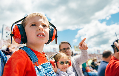 Child wearing hearing protection at an air show.