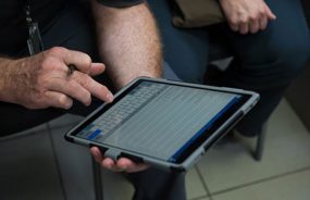 A man entering data into a computer tablet.