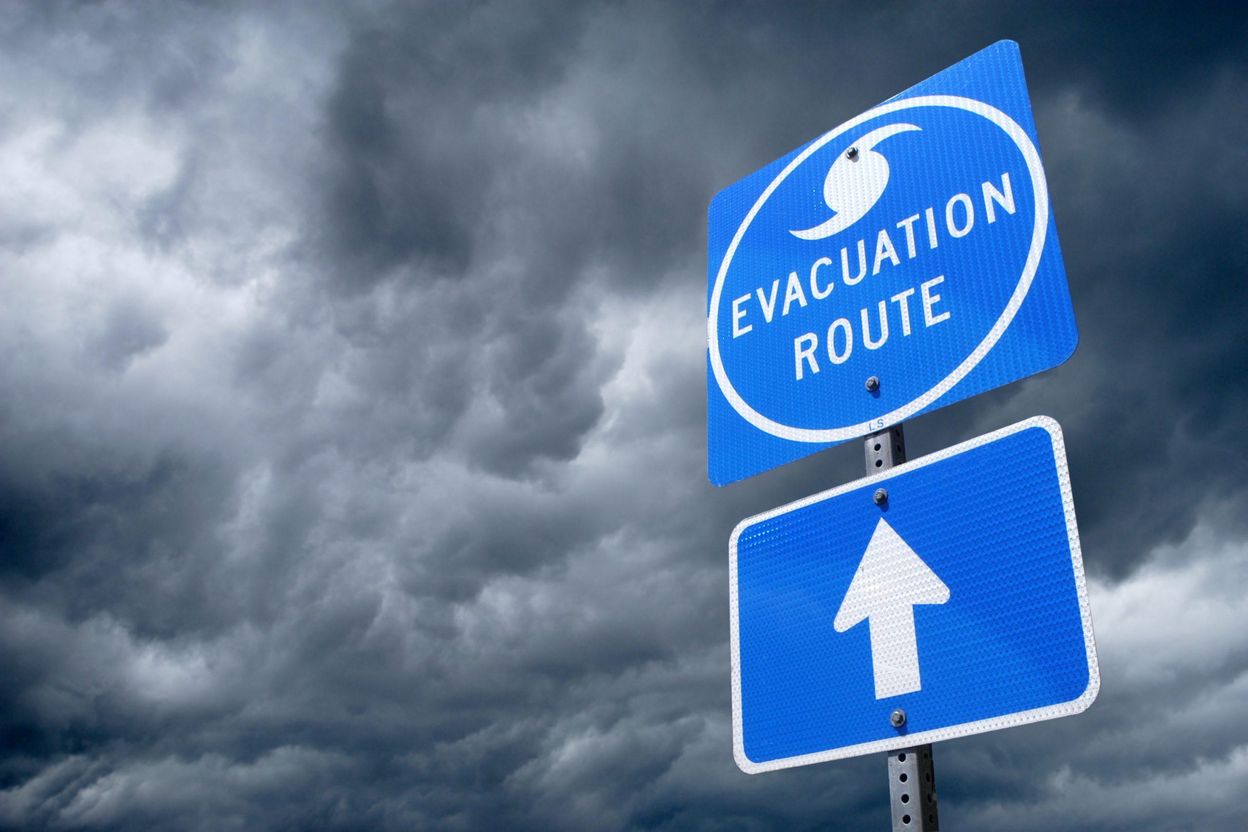 A blue sign that says, "Evacuation route"