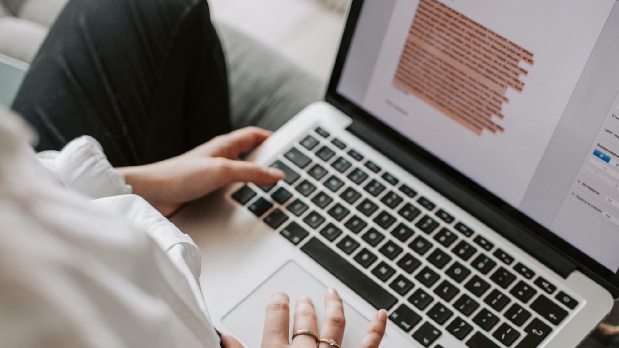 A hand typing on a laptop