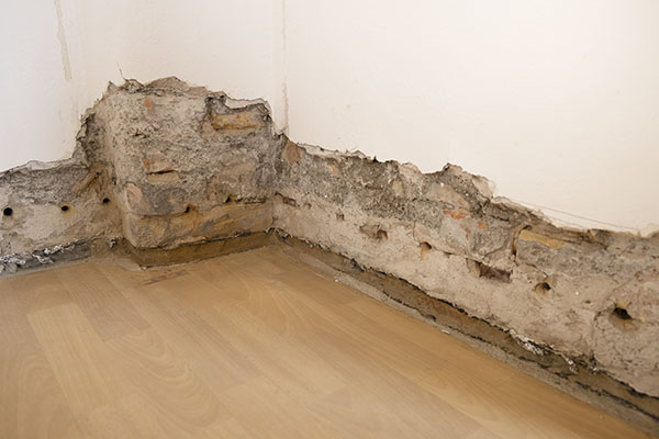 Dry wall removed from wall to show old wall with damage