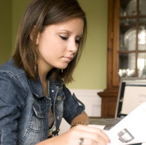 Woman reading papers at a desk