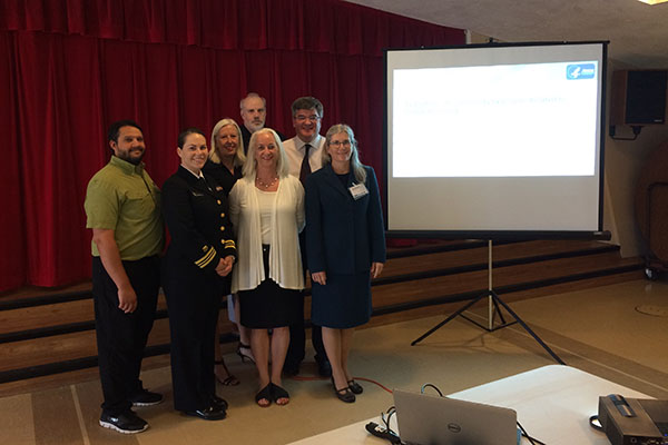 CWC Team standing in front of presentation screen