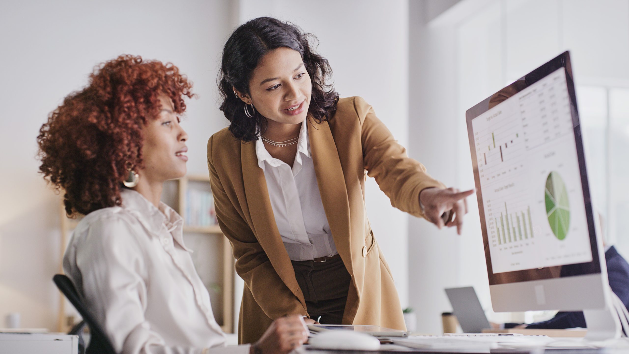 Employee women in teamwork collaboration looking at company data or analysis on PC