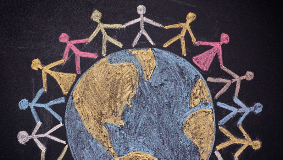 color chalk drawing of a globe with stick figures of children holding hands around it