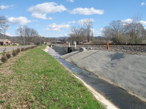 East draining ditch from the former PCB production facility (paved during PCB clean-up efforts in late 1990s).